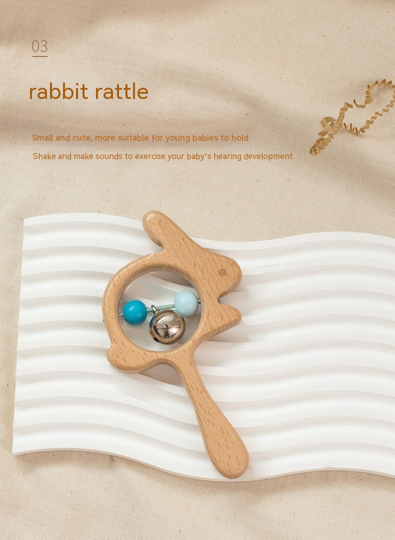 Wooden rabbit rattle toy on a textured beige background Montessori bleu ribbon baby