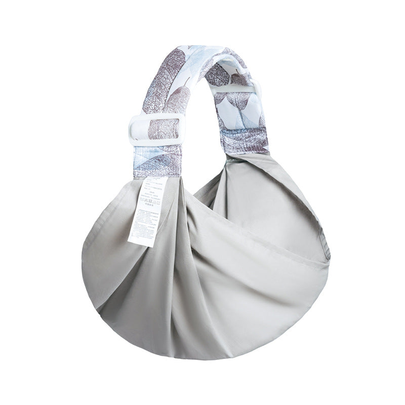 Gray baby carrier with patterned strap on a white background mash baby carrier bleu ribbon baby