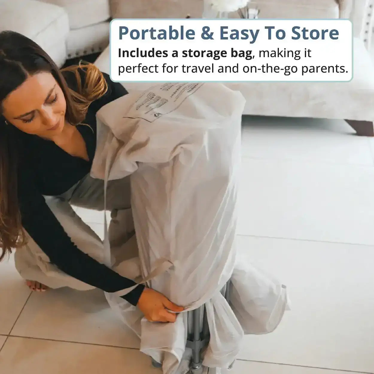 Woman holding a baby outfit with text about portability and storage. All Stars JOY Baby Playpen Natural Edition by Venture.