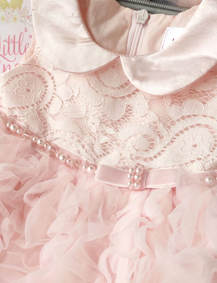 Close-up of a pink lace dress with ruffles and a bow, featuring a brand label. Baby Girl Lace Dress Gift Box Christening Birthday Outfit bleu ribbon