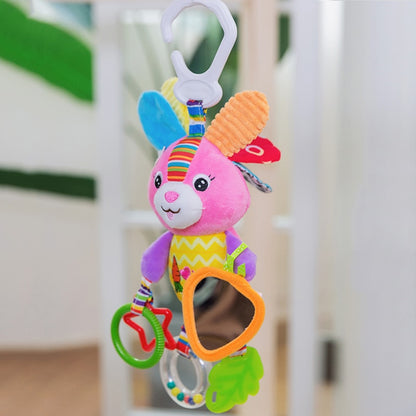Colorful baby toy with a rabbit design hanging against a blurred indoor background bleu ribbon