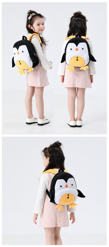 Child wearing a penguin backpack from front, side, and back views. bleu ribbon
