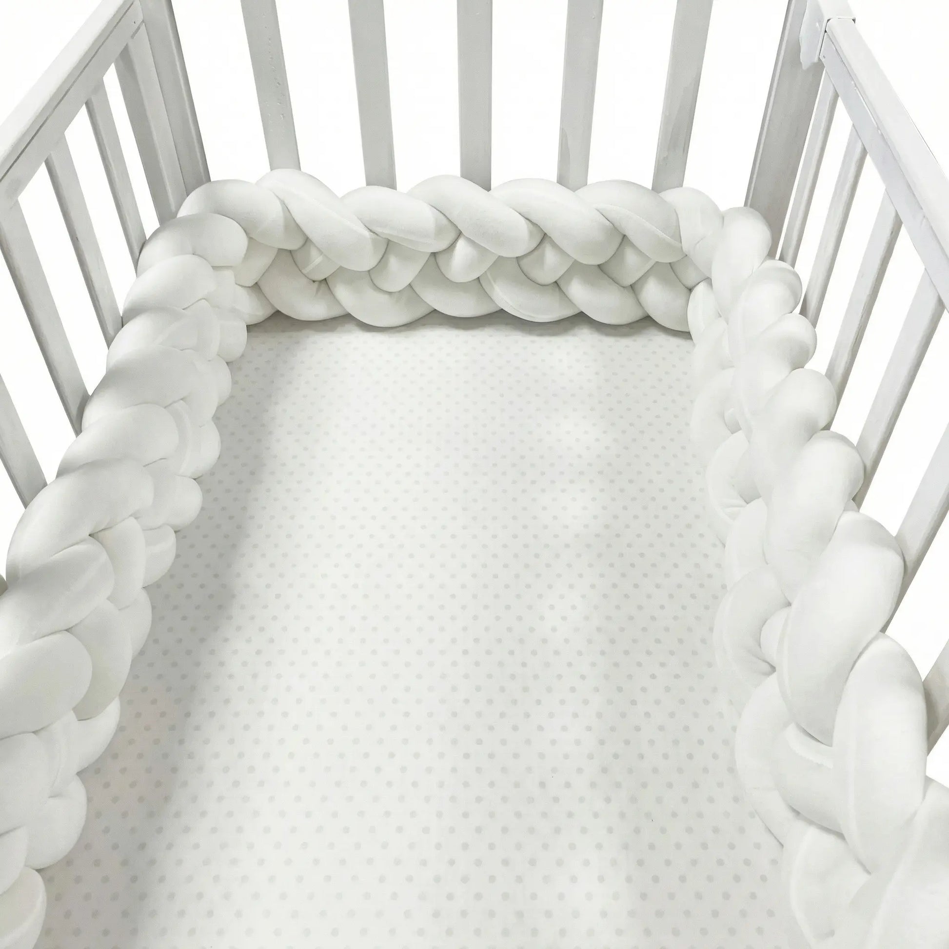 White braided crib bumper around a crib. CozyGuard Braided Crib Bumpers Safe Nursery Protectors BleuRibbon Baby