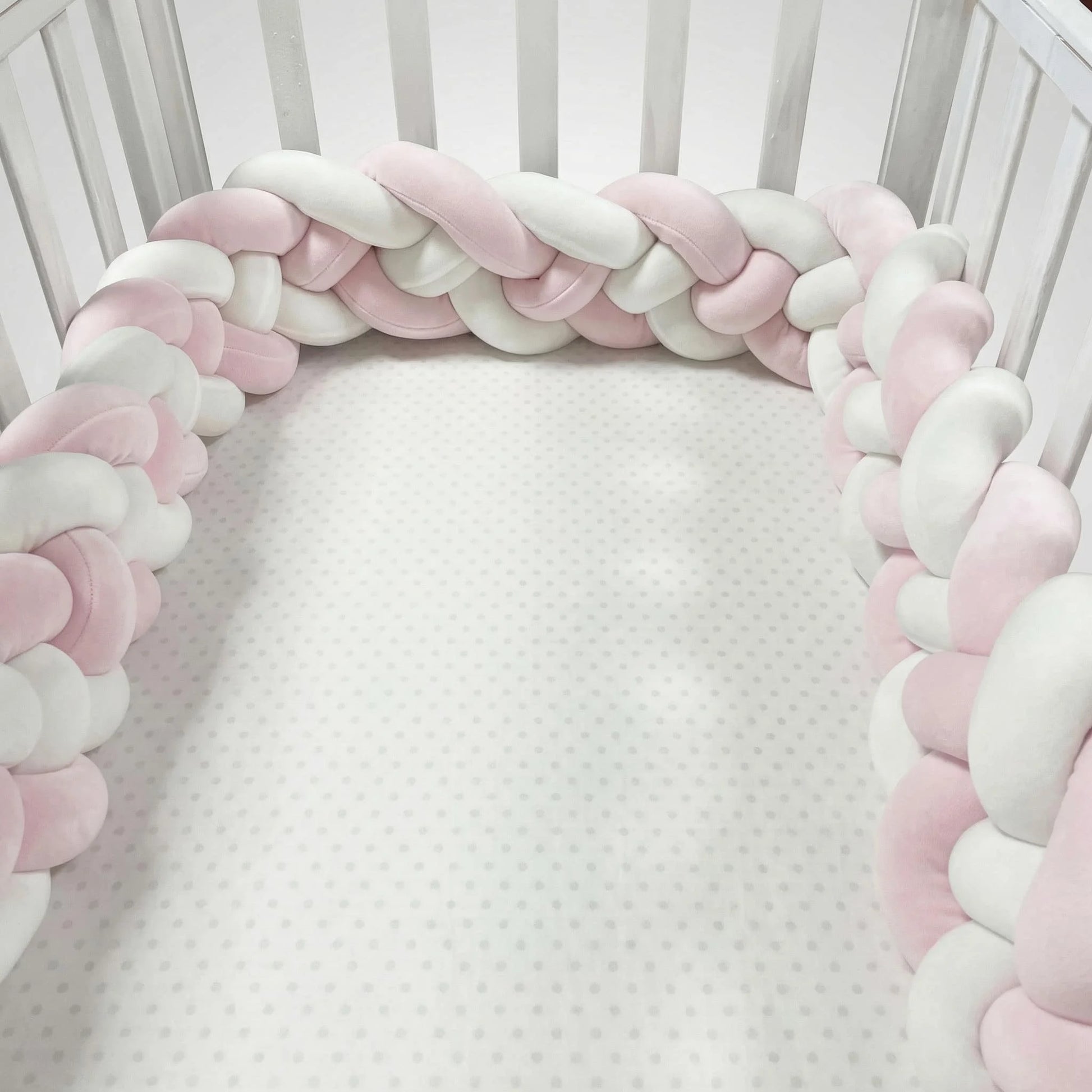 Braided pink and white bumper in a crib. CozyGuard Braided Crib Bumpers Safe Nursery Protectors BleuRibbon Baby