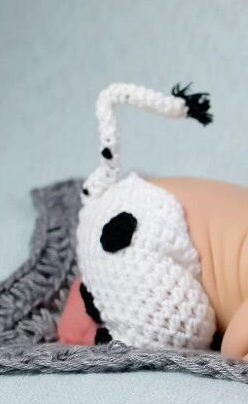 Adorably crafted hand-knitted baby cow suits