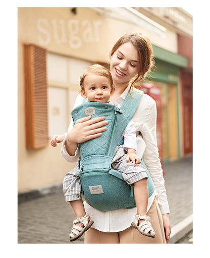 Woman carrying a child in a blue baby carrier on a street. Easy-On Baby Carrier SwiftWear Ergonomic Infant Carrier for Dads Moms bleu ribbon