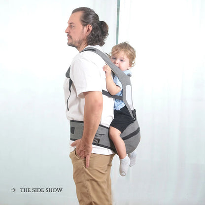 Man using a baby carrier with a child on a plain background bleu ribbon