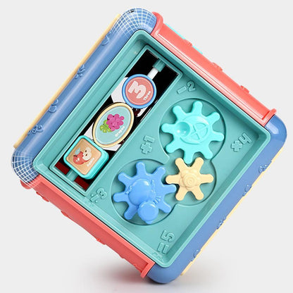 Colorful toy with gears and buttons on a light gray background bleu ribbon