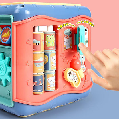 Colorful children's toy with interactive elements and a hand pressing a button on a pink background bleu ribbon