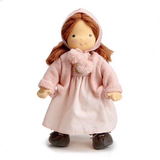 Doll wearing a pink dress and coat on a white background. Liselie Doll by ThreadBear Design - Waldorf-style textile ragdoll in gift box