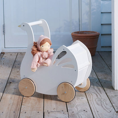 Wooden goose-shaped pram with a doll on a wooden deck. Liselie Doll by ThreadBear Design - Waldorf-style textile ragdoll in gift box