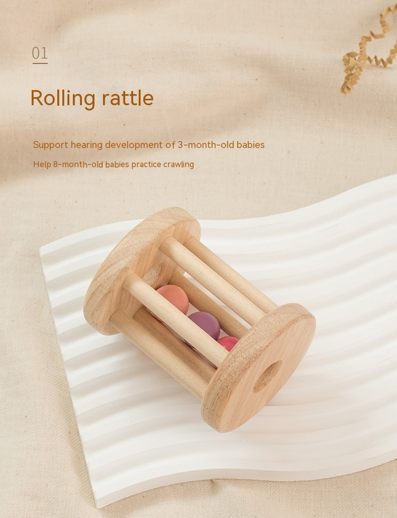 Wooden rolling rattle toy on a white blanket with text about its benefits for babies. bleu ribbon baby