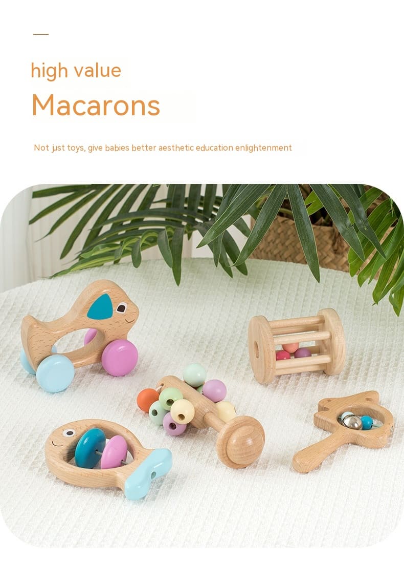 Set of wooden toys with colorful beads on a white surface with greenery in the background. bleu ribbon baby Montessori