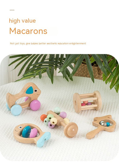 Set of wooden toys with colorful beads on a white surface with greenery in the background. bleu ribbon baby Montessori