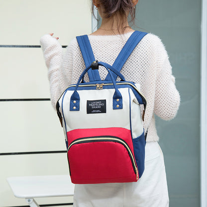 Person wearing a white, red, and blue backpack with a visible brand label. bleu ribbon