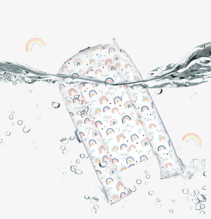 Reusable shopping bag with rainbow pattern partially submerged in water on a white background bleu ribbon baby
