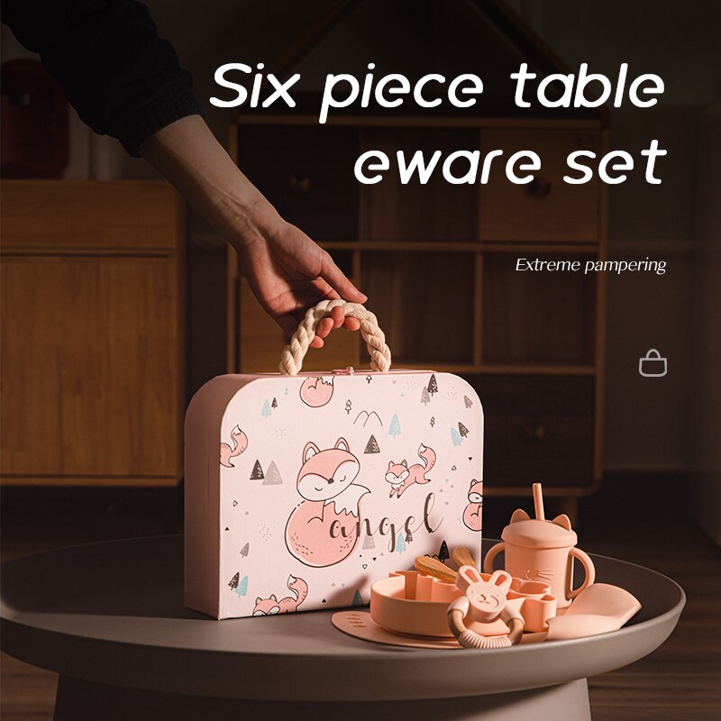 Six piece tableware set with a pink suitcase on a dark surface bleu ribbon baby