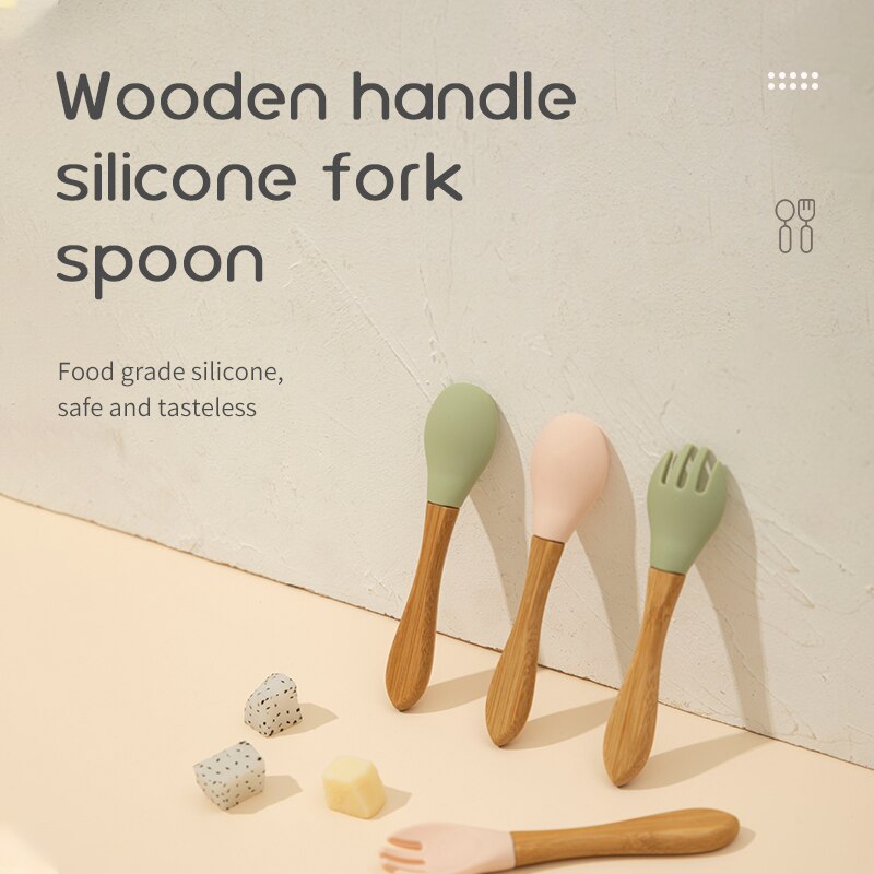 Set of wooden handle silicone fork and spoon on a neutral background bleu ribbon