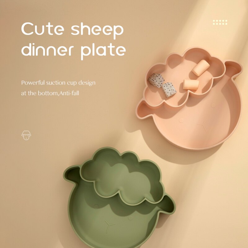 Two sheep-shaped dinner plates, one pink and one green, on a beige background with text describing the product. bleu ribbon baby