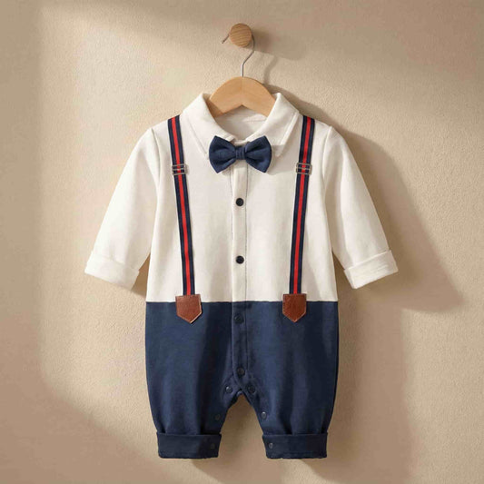 Stylish infant tuxedo style jumpsuit hanging on a wooden hanger in a boutique nursery setting. Elegant formal wear for baby boys.