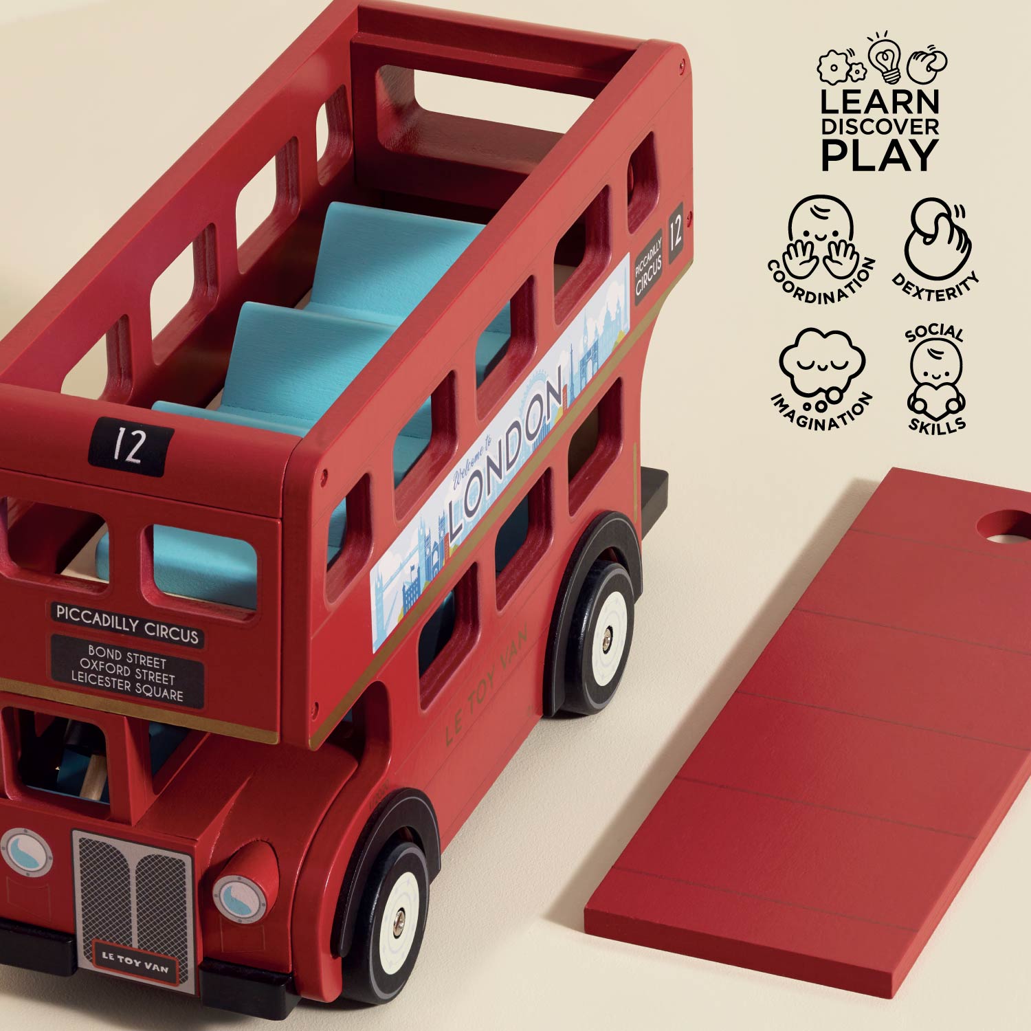 Red toy double-decker bus with a blue interior on a beige background, London Wooden Bus by Le Toy Van
