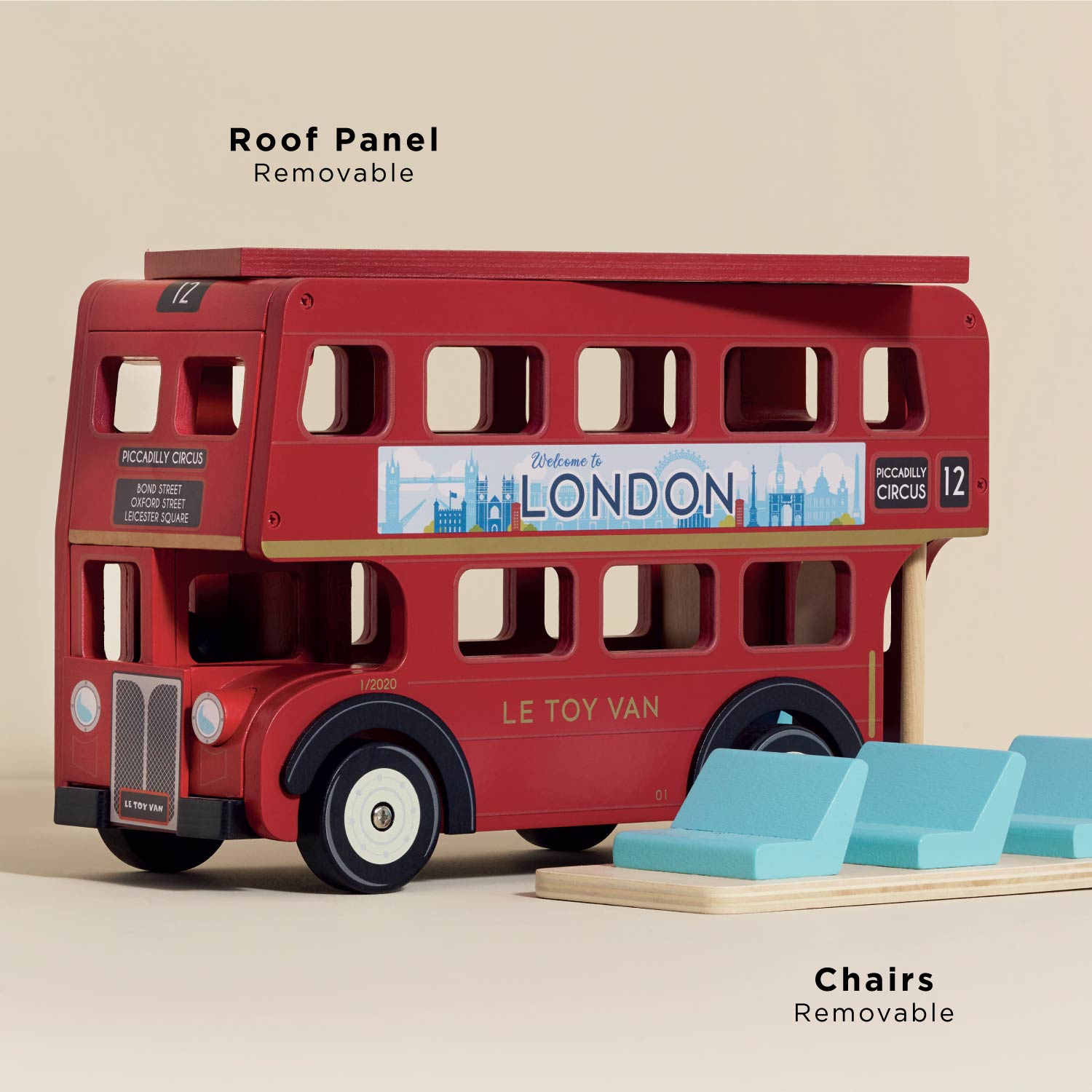 London Wooden Bus by Le Toy Vanwith removable roof panel and chairs on a beige background.