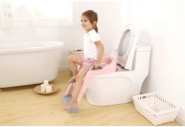 Child using a potty seat on a toilet in a bathroom setting bleu ribbon