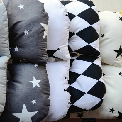 Collection of decorative pillows with various patterns including stars, checkers, and plain colors. bleu ribbon