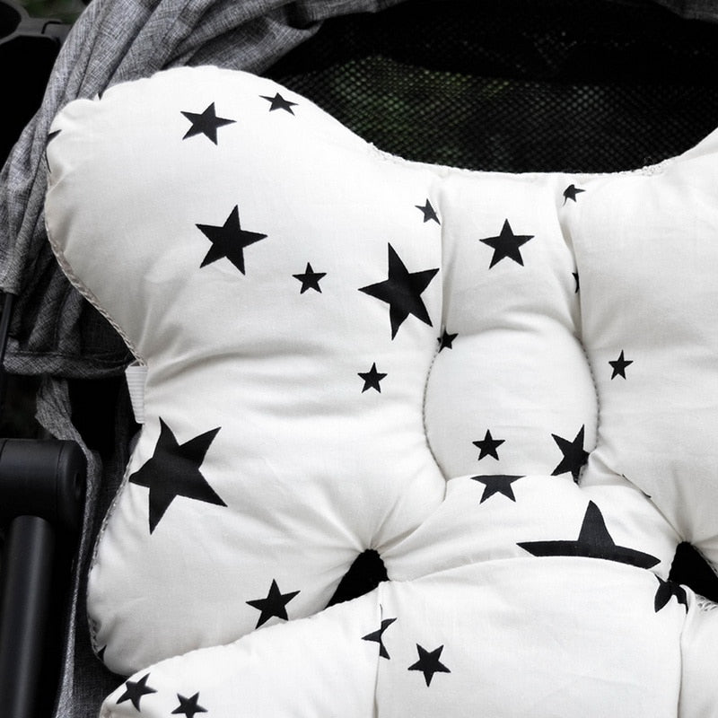 White cushion with black star patterns on a stroller seat. Universal Stroller Cushion Thick Baby Car Seat Liner & Headrest bleu ribbon