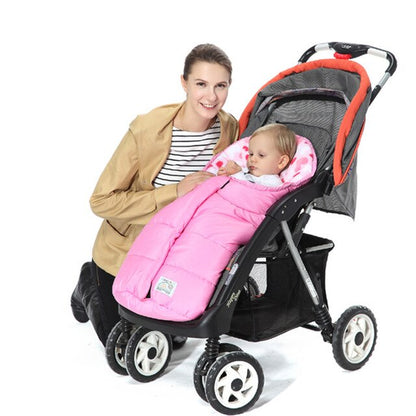 Woman holding a baby in a pink stroller cover, with a black stroller on a white background bleu ribbon baby