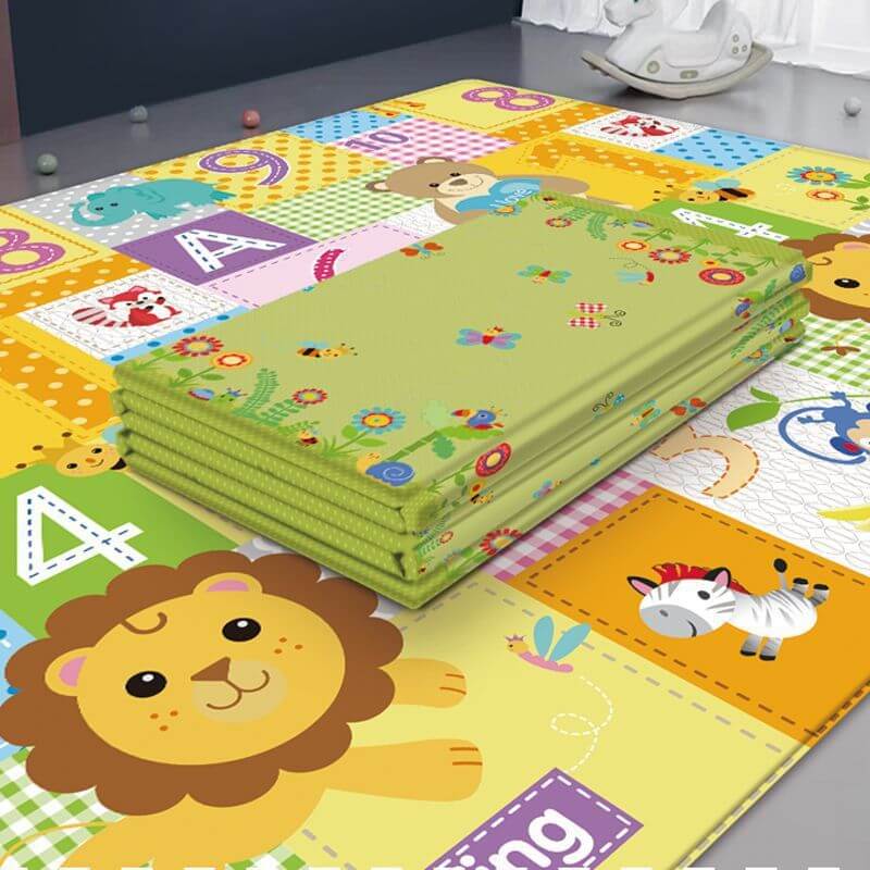 BleuRibbon Baby Crawling Mat with Lion King and Green World patterns, safe and eco-friendly for baby playtime.