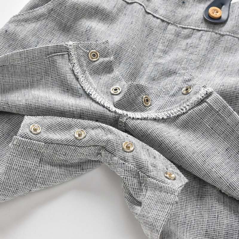 Close-up of a gray checkered shirt with buttons on a white background bleu ribbon