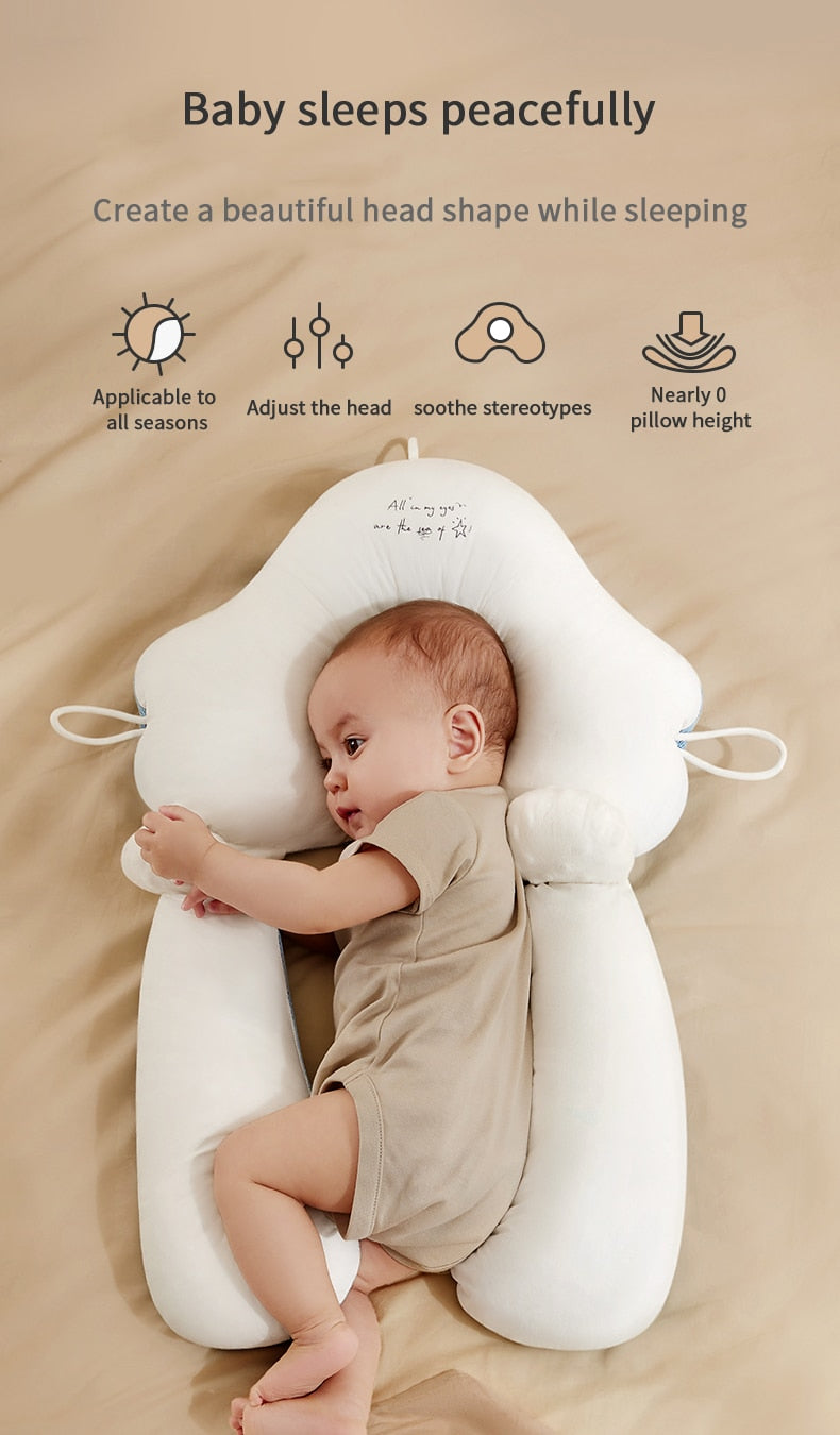 Baby sleeping peacefully on ergonomic pillow with near zero height design to protect cervical spine.