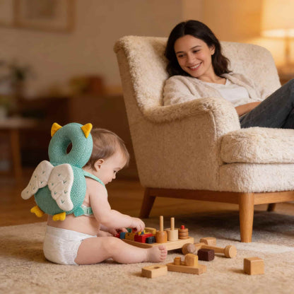 Mother watching her baby play safely while wearing the BleuRibbon head protector. Essential baby proofing gear for walkers.