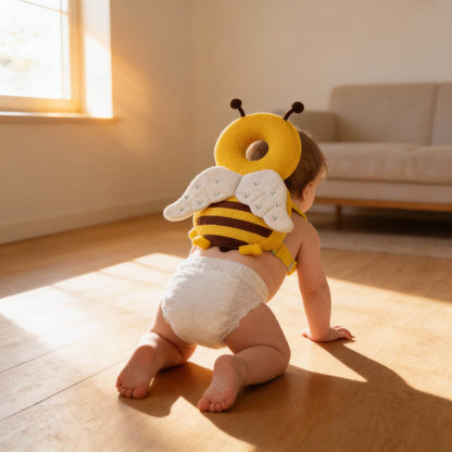 Toddler wearing BleuRibbon bee-shaped safety backpack, crawling safely in a sunlit room. Protects baby's head and back during falls.