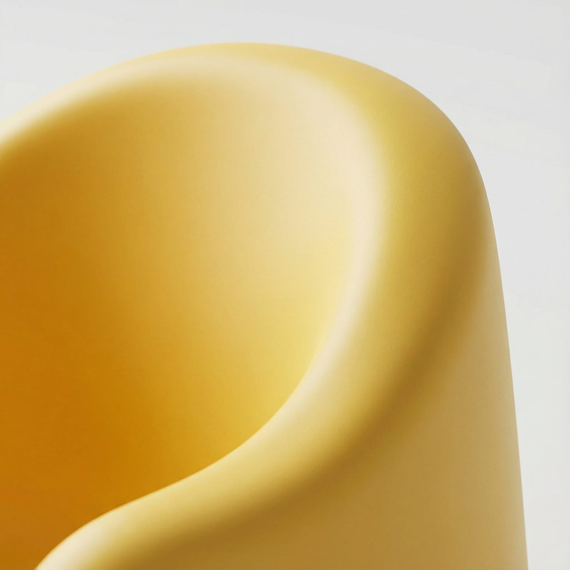 Extreme close-up detailing the smooth, matte finish of the yellow BleuRibbon bath seat. Shows high-quality, BPA-free plastic material with gentle, rounded edges designed for baby's sensitive skin.