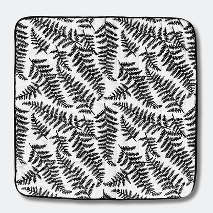 Full top view of the square Etta Loves outdoor playmat displaying the high-contrast black and white sensory fern pattern designed for visual development.