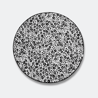 Top view of the high-contrast black and white Fairford Shadow side of the Etta Loves x Liberty round playmat, optimized for newborn visual development.