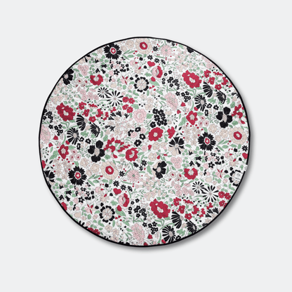 Top view of the circular, colorful Wharfedale Meadow side of the Etta Loves x Liberty sensory playmat, designed for babies from 5 to 12 months.