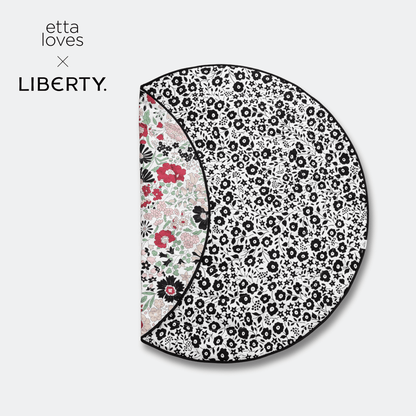Etta Loves x Liberty collaboration logo next to the folded round reversible sensory playmat displaying both developmental stages.
