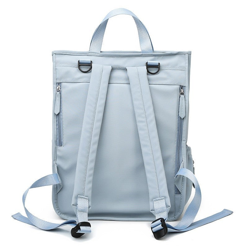Wide open diaper bag showing large capacity and organized compartments.