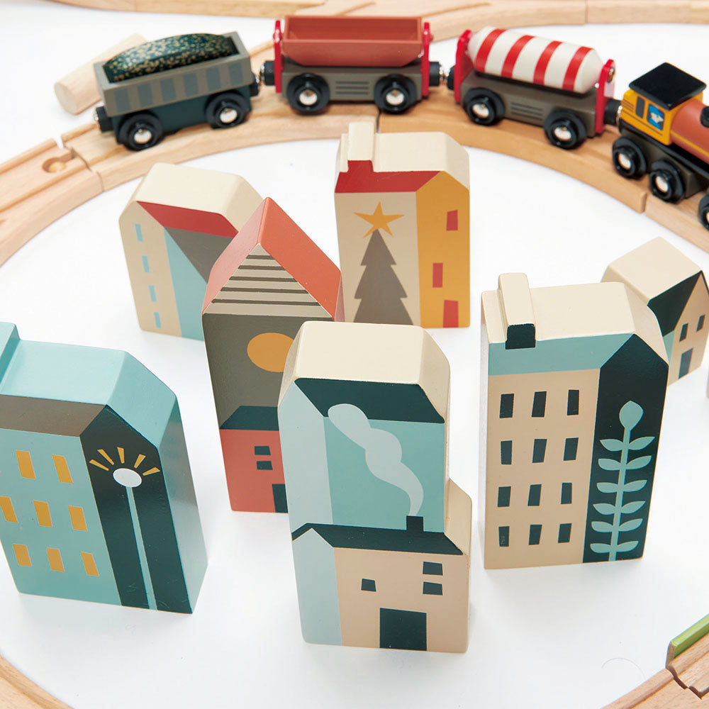 Wooden toy train set with colorful houses on a white background Mountain View Wooden Train Set 58-piece set by Tender Leaf Toys