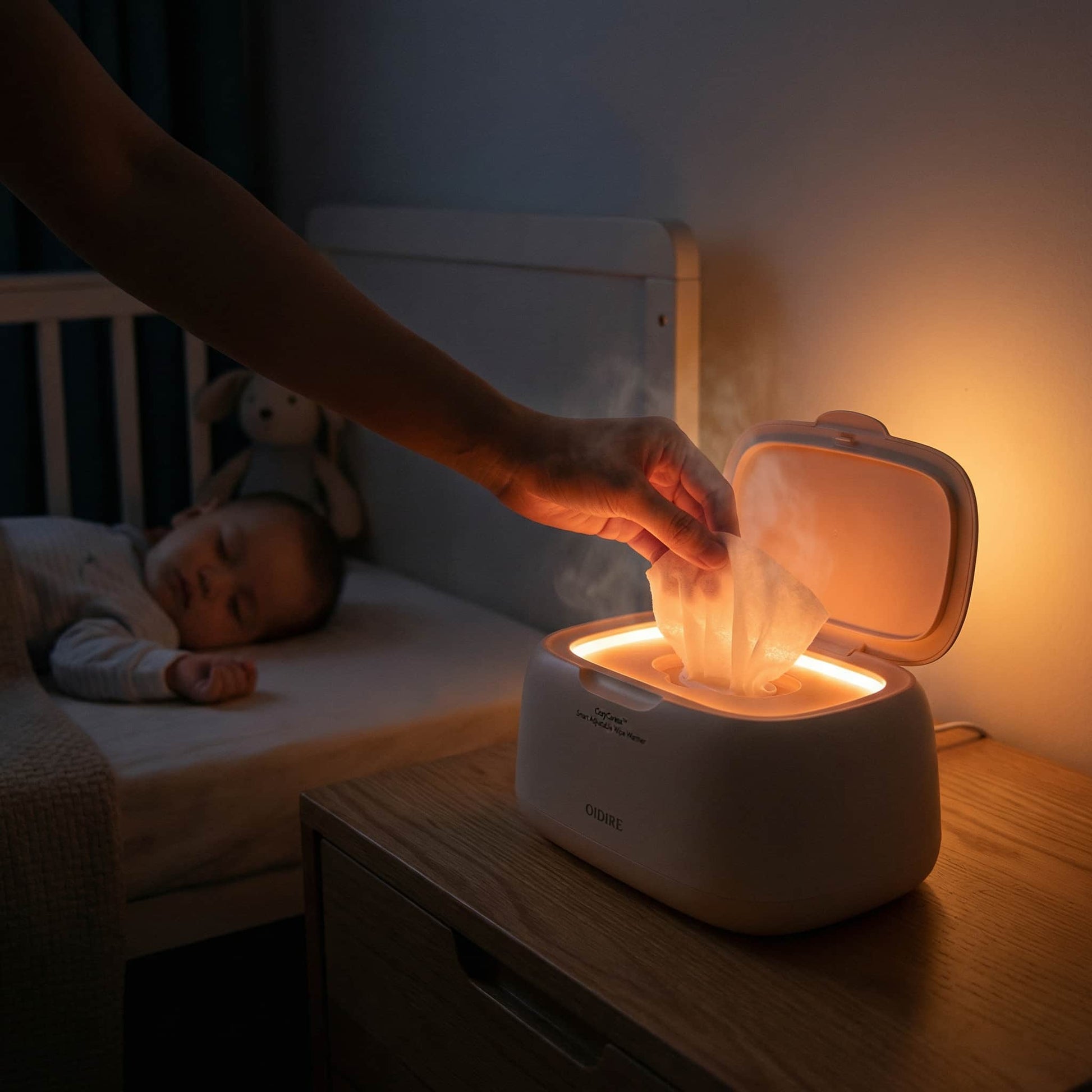 Dimly lit nursery at night showing the soft, warm ambient light of the wipe warmer, keeping baby asleep during midnight diaper changes.