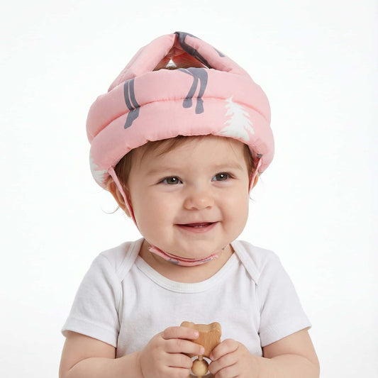 Pink SafePlay infant safety helmet with grey deer pattern isolated on white background, showing soft cushioning and adjustable straps.