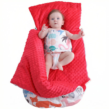 BleuRibbon Baby fleece stroller quilt with hood. Baby sitting on a red minky dot blanket with a white background