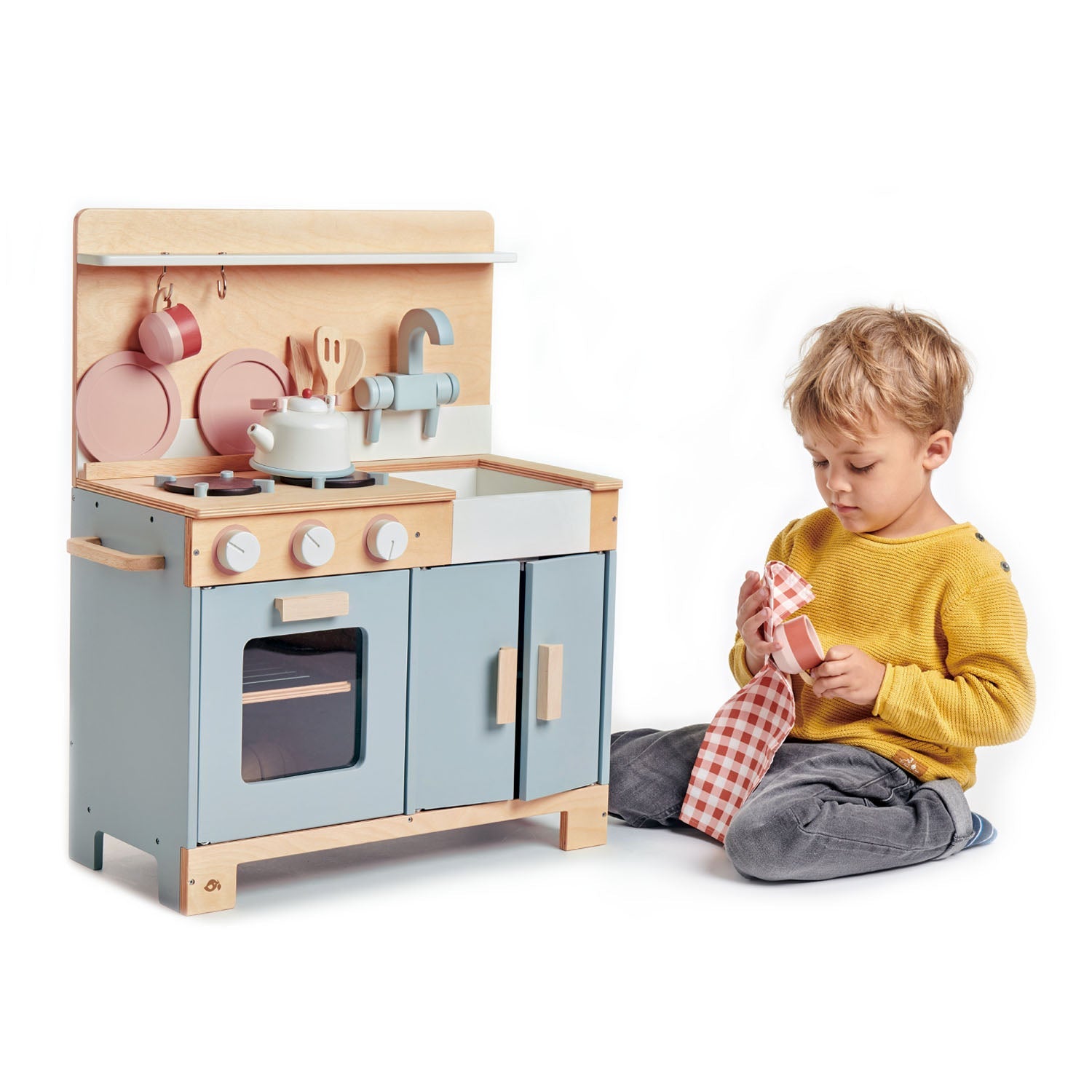 Child playing with a toy kitchen set on a white background Macro shot of the sustainable rubberwood and top-quality plywood texture, emphasizing the eco-friendly and durable nature of the product.